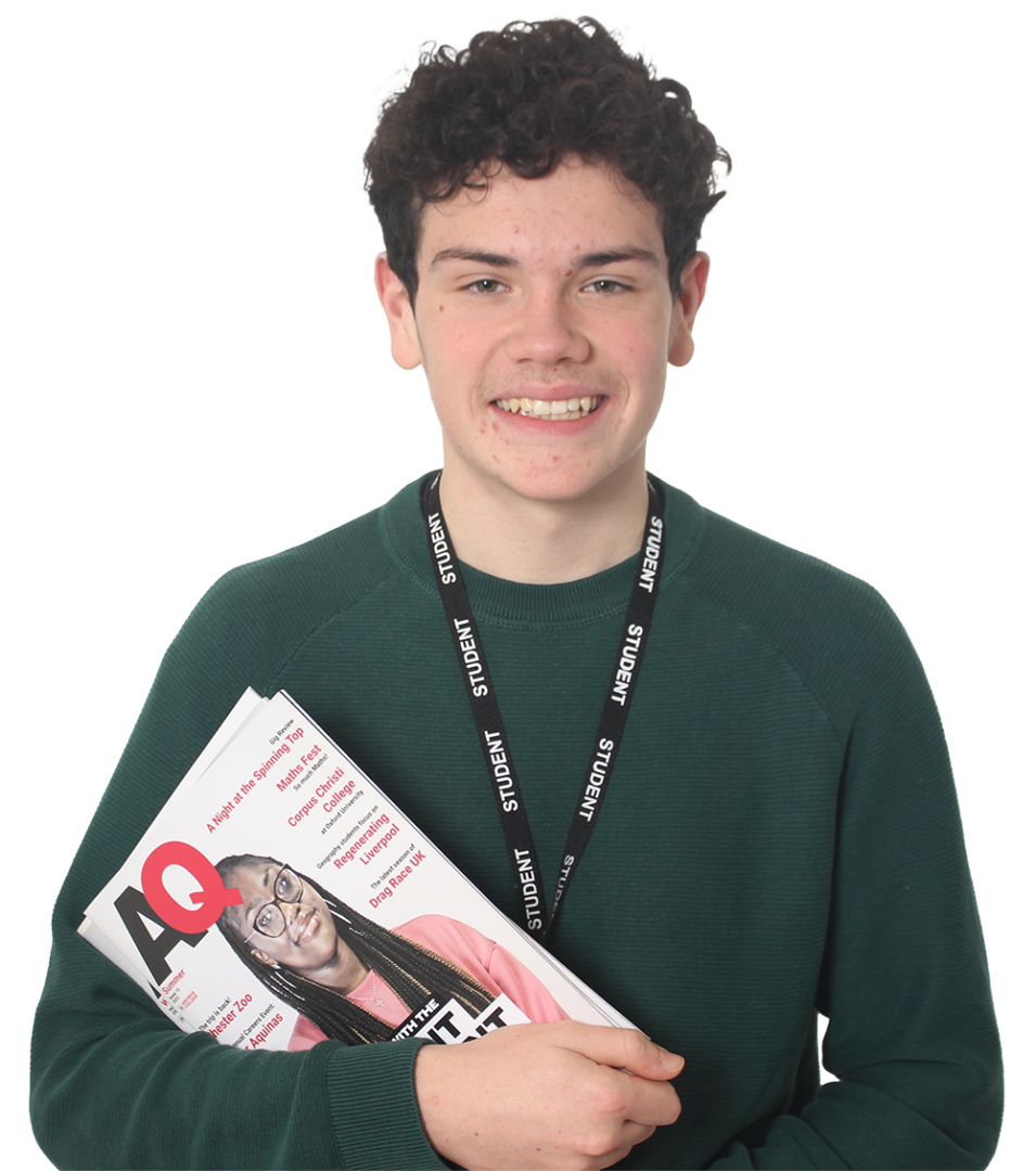 Student holding up a copy of the AQ Magazine