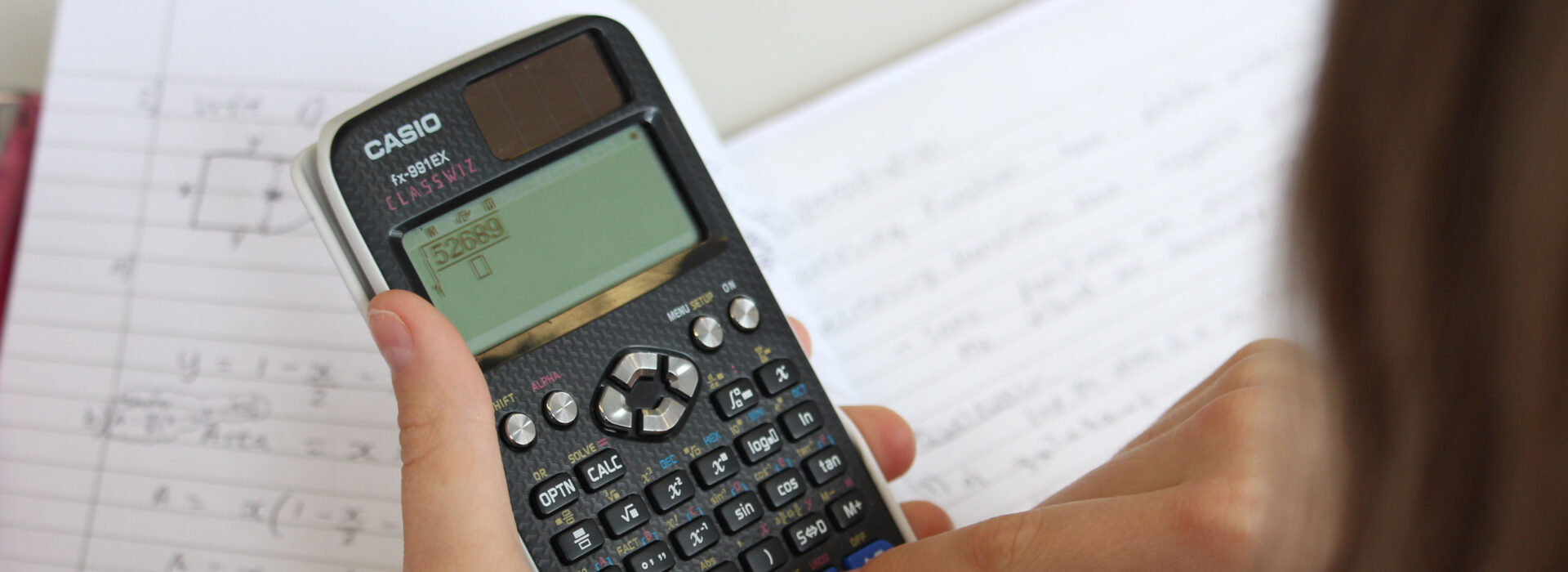 Photograph of a student holding a calculator