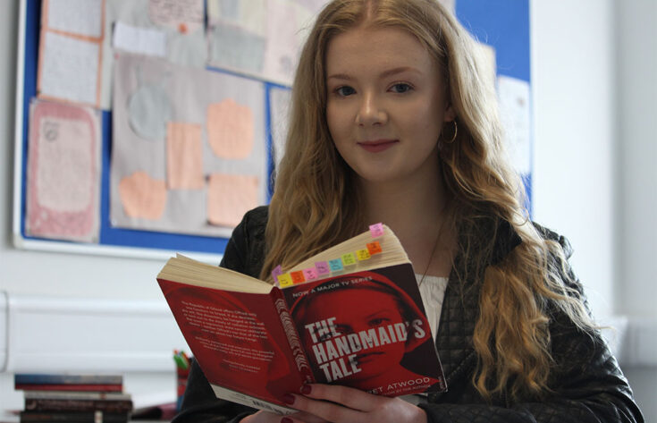 Photograph of a student studying the Handmaid's Tale