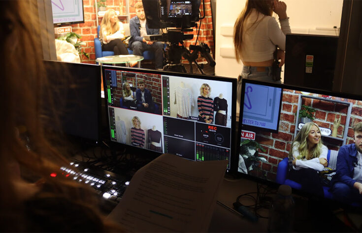 Photograph of students producing a mock live TV programme in the studio.