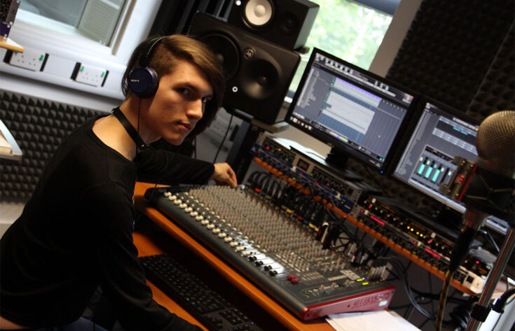 Photograph of a Music Technology student operating a mixer