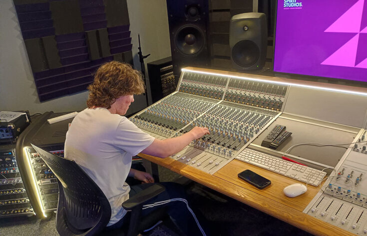 Photograph of a student operating a mixing desk at Spirit Studios